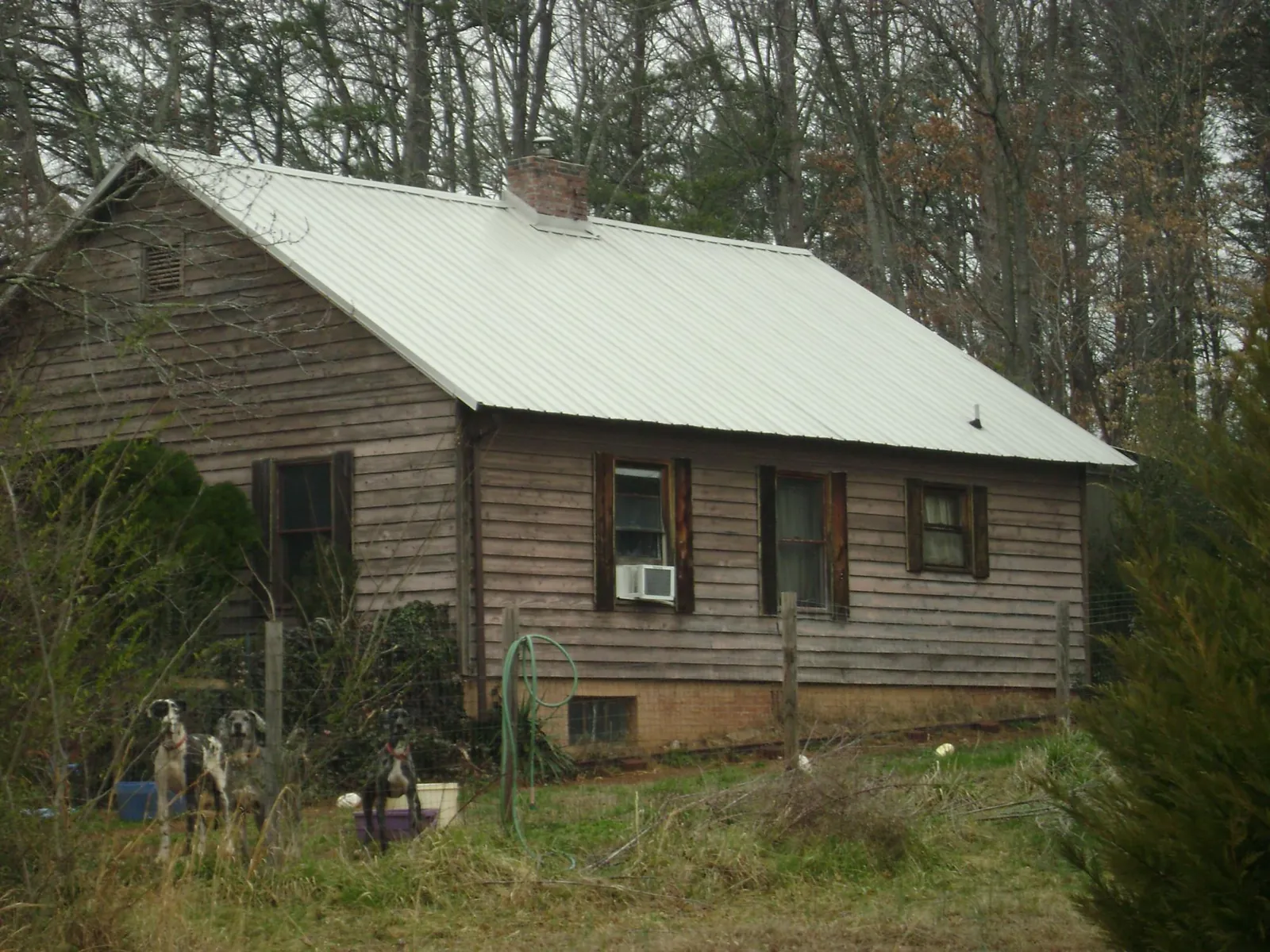 White metal roof on an old wood sided farmhouse, from a Metal Roof Installation job in Lisbon